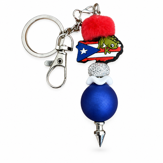 Puerto Rico Coquí flag keychain with red pom-pom and blue bead on white background