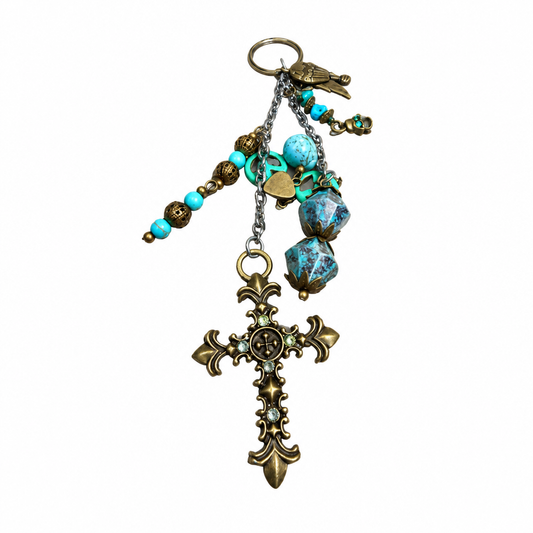 Vintage cross charm keychain with turquoise beads and patina details on white background